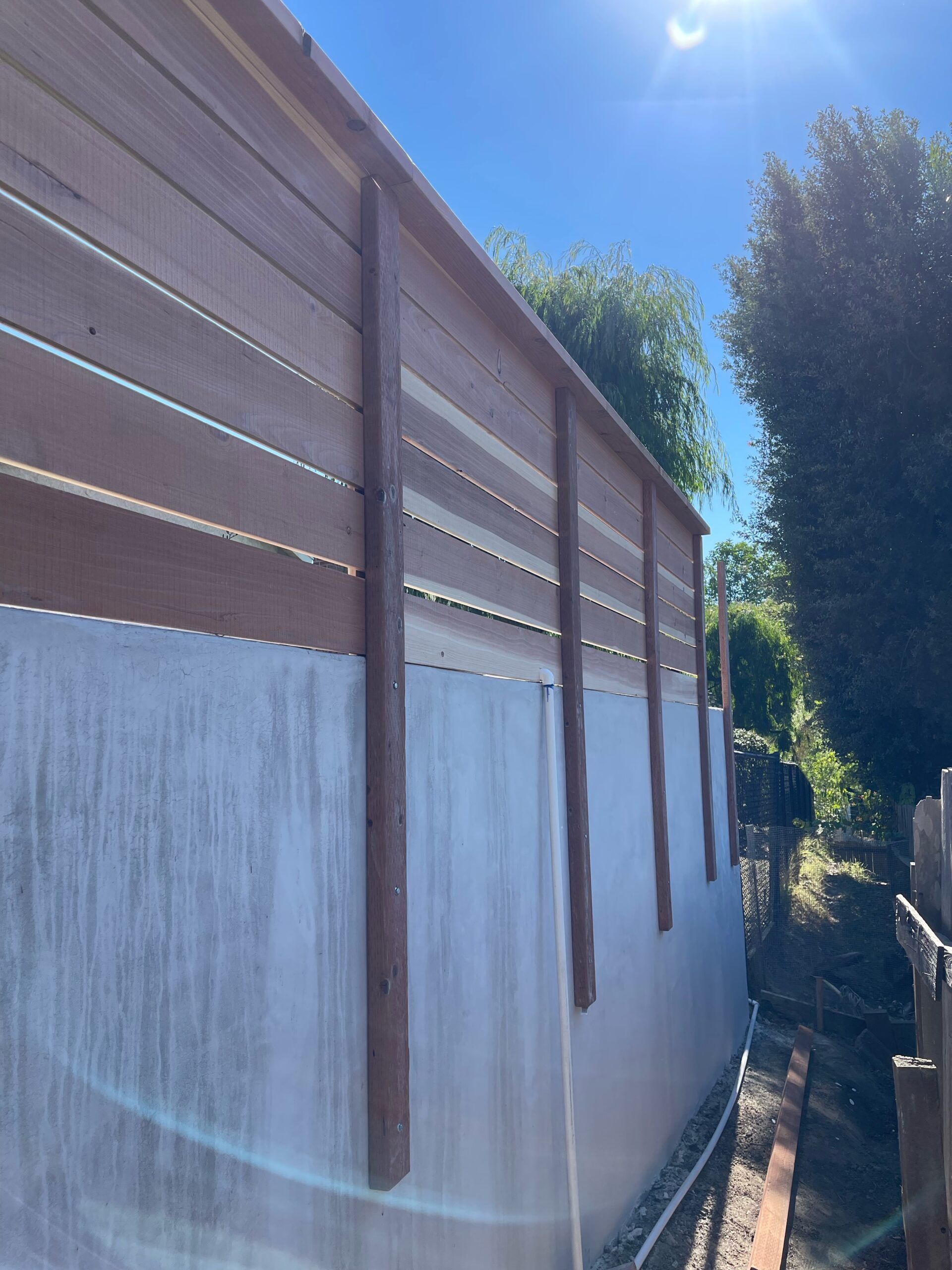 3_ tall horizontal fence on retaining wall