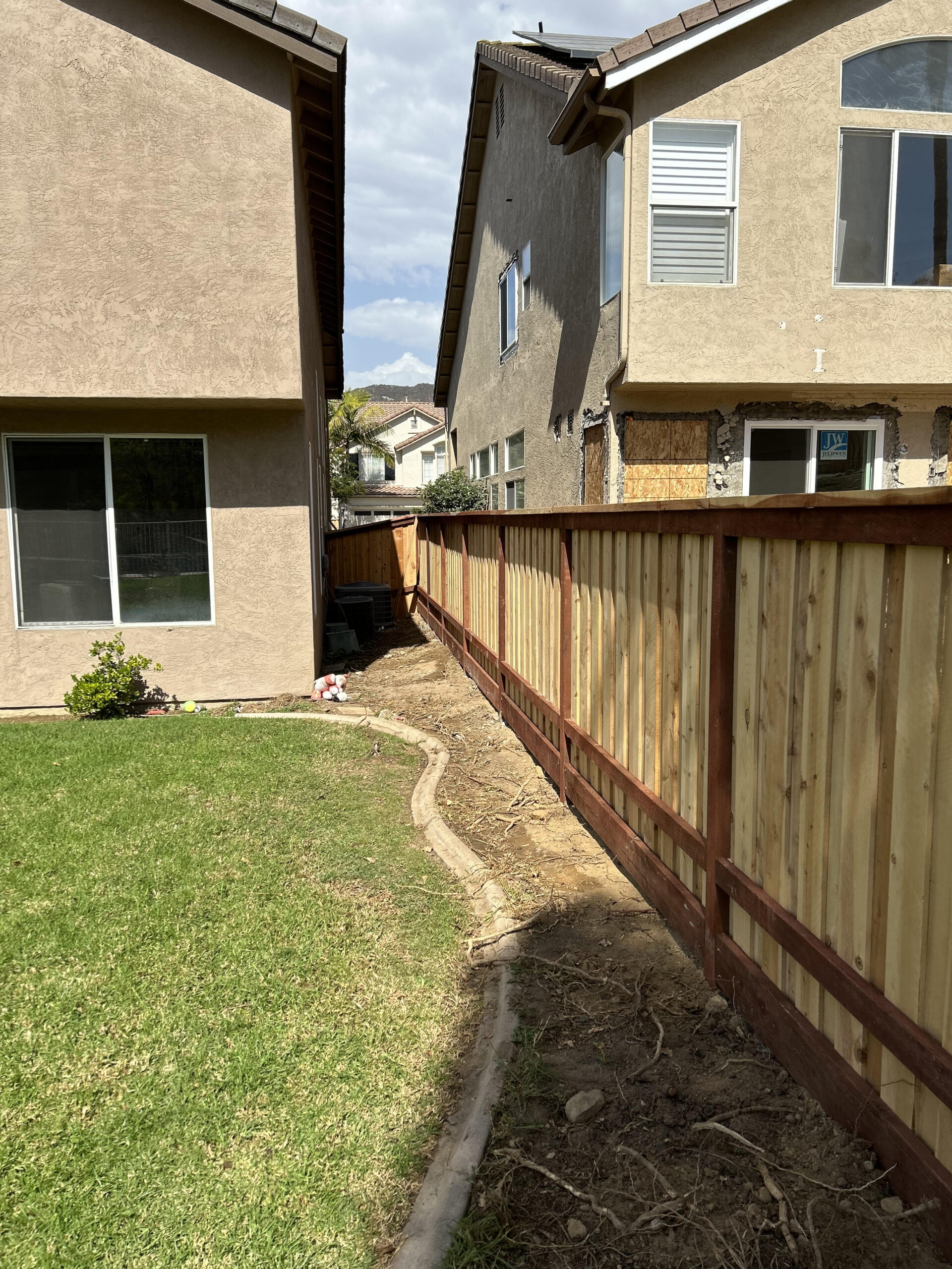 Clean straight line wood fence made of cedar.