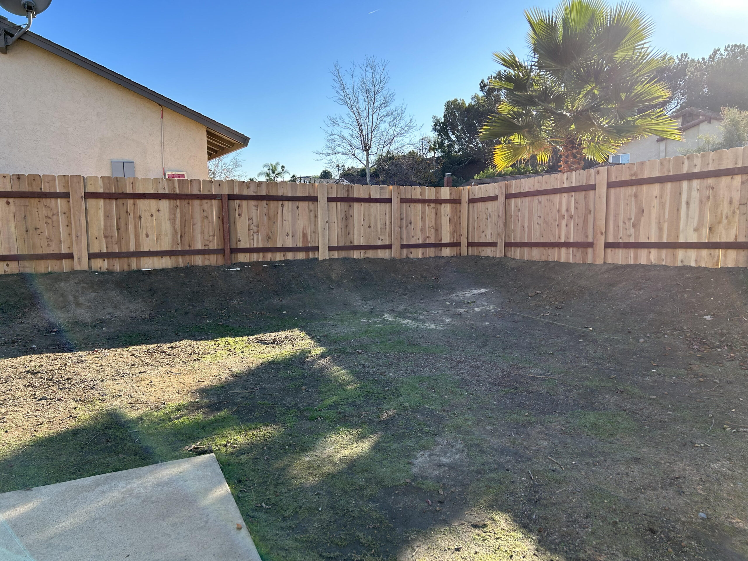 Standard wooden Fence Metal Posts on hill in San Diego 