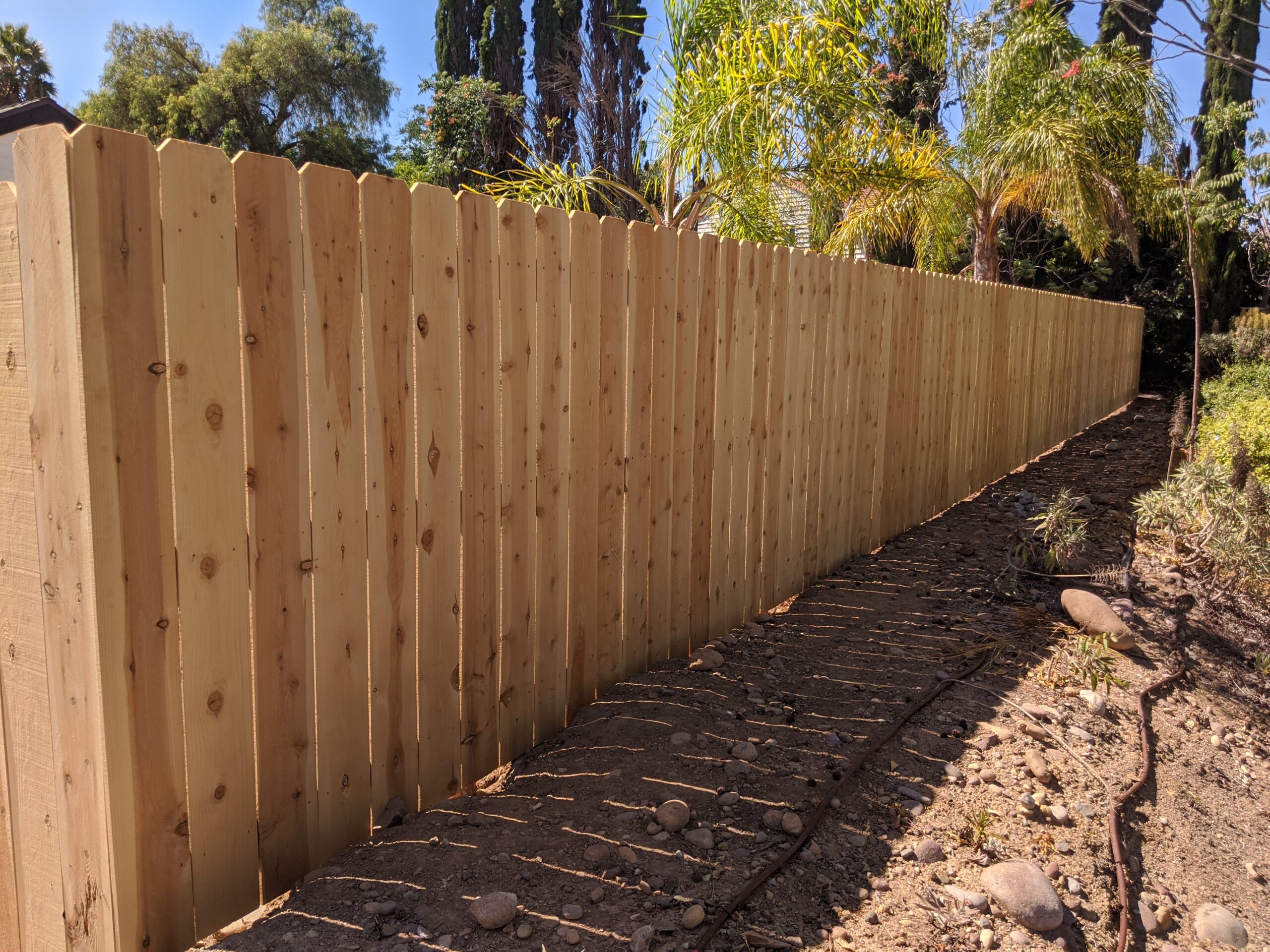 Clean straight line wood fence made of cedar.