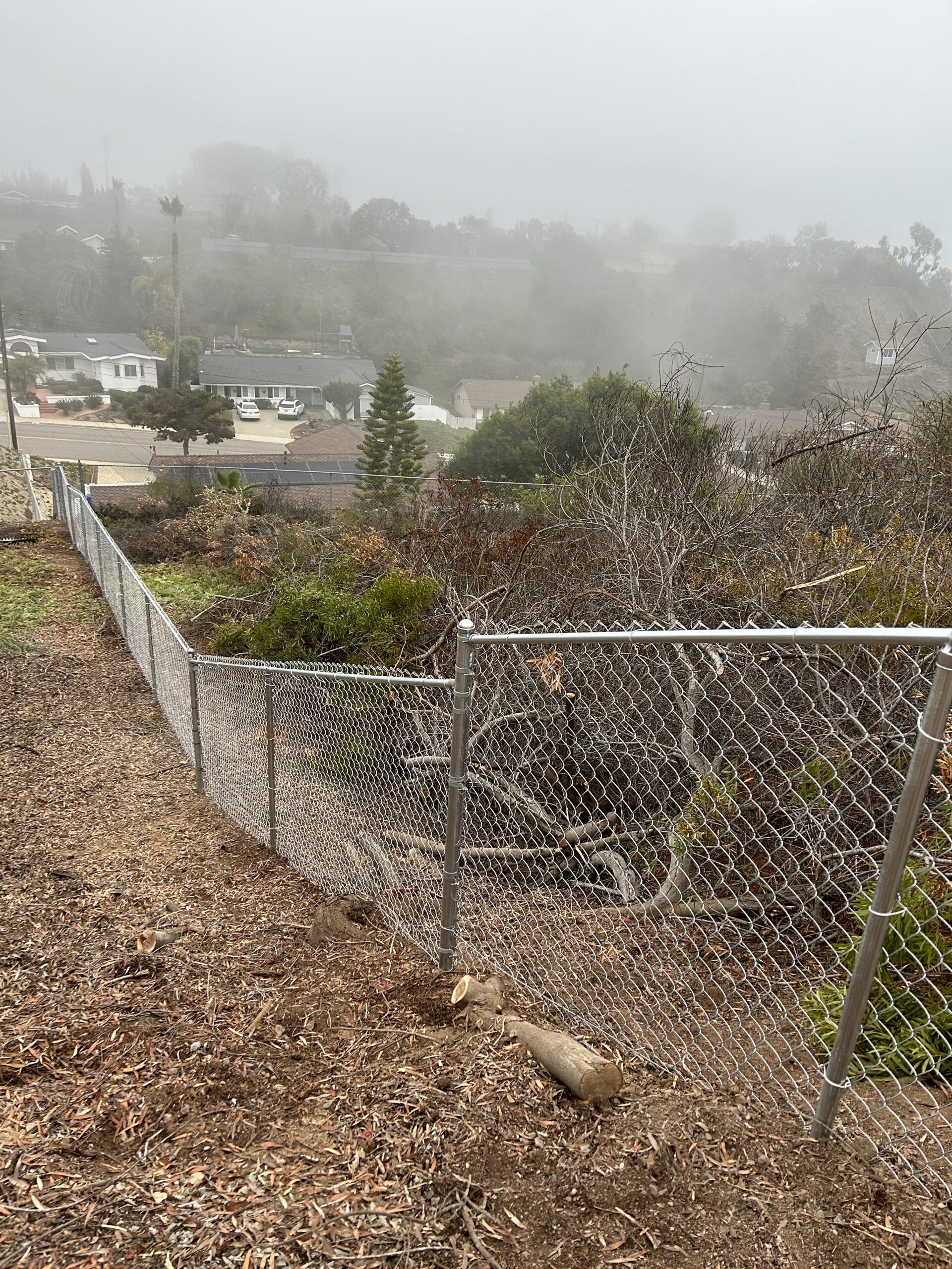 Chain Link fence up steep hill in San Diego