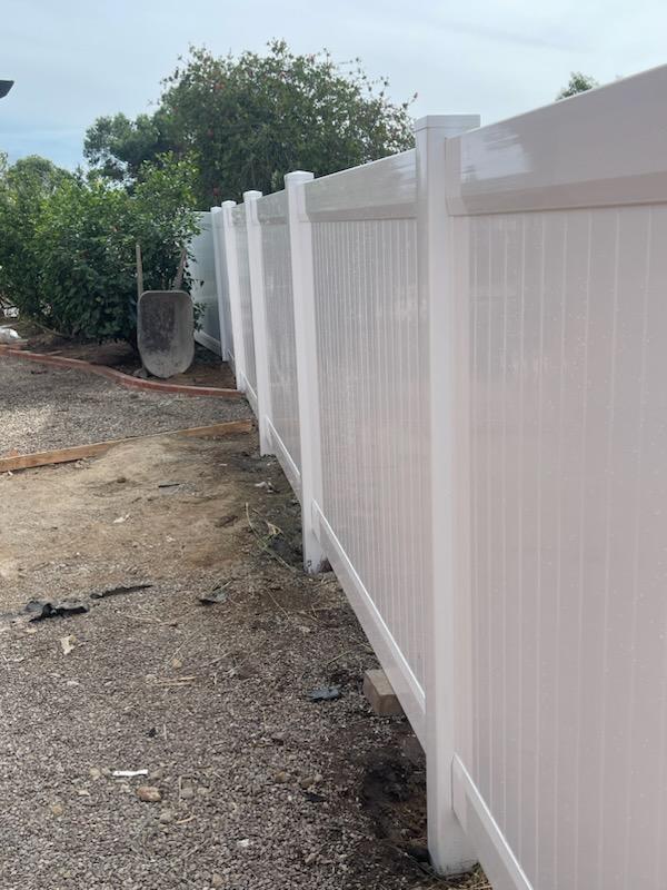 White vinyl privacy fence installation