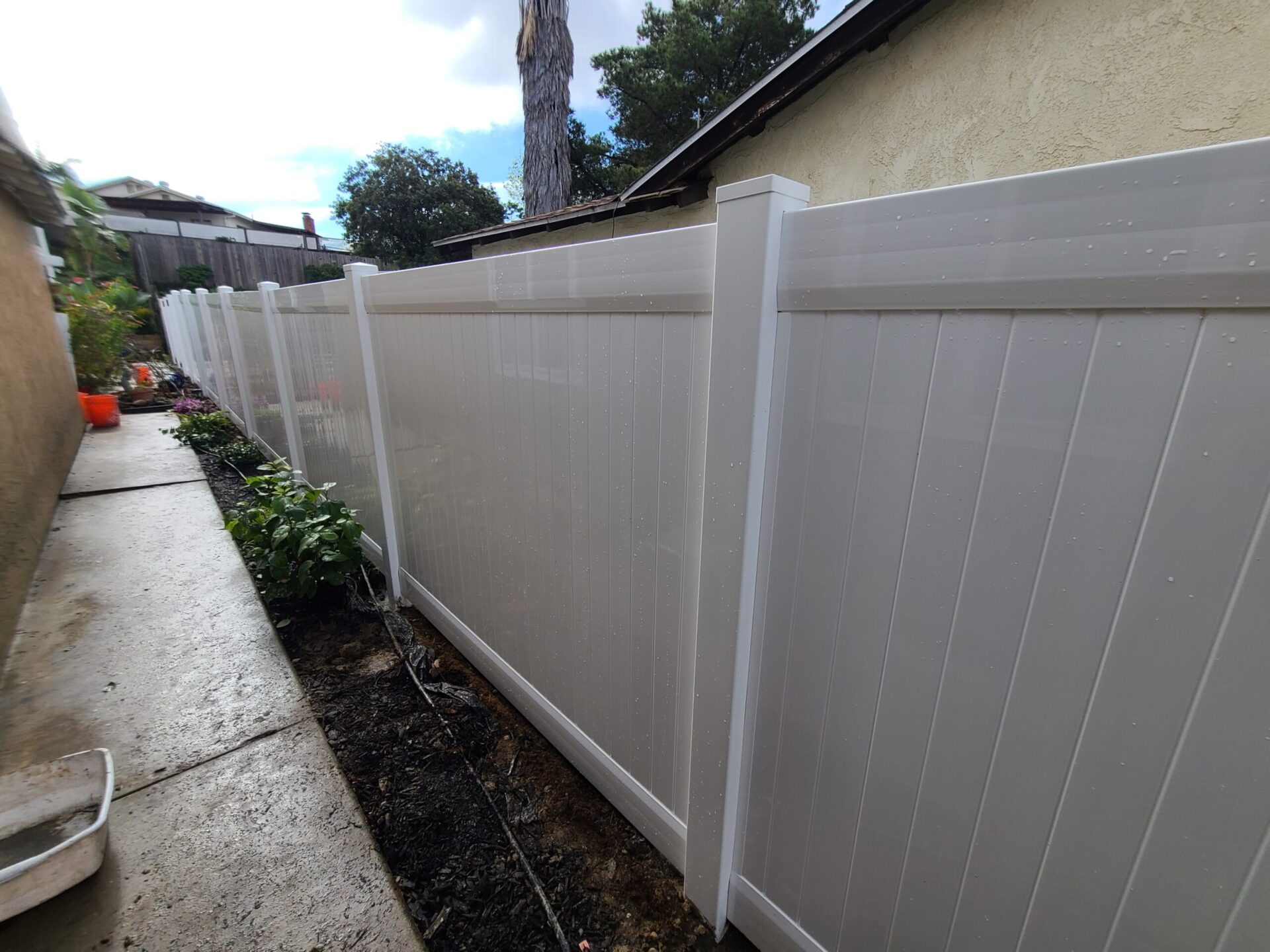 White vinyl fence install on residential property in San Diego County
