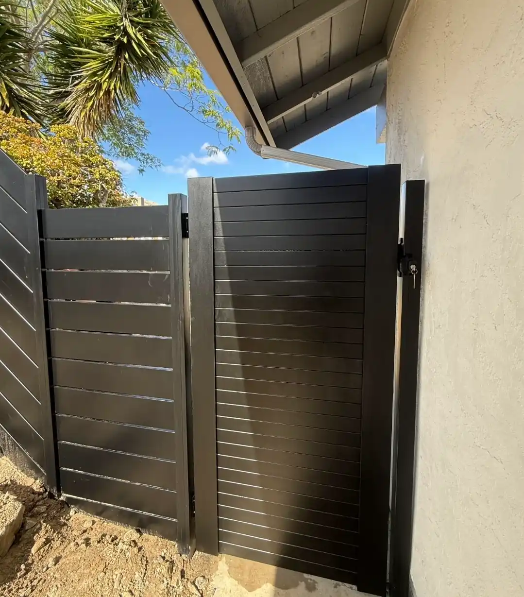Custom black aluminum privacy gate and matching horizontal fence installed at a San Diego residence